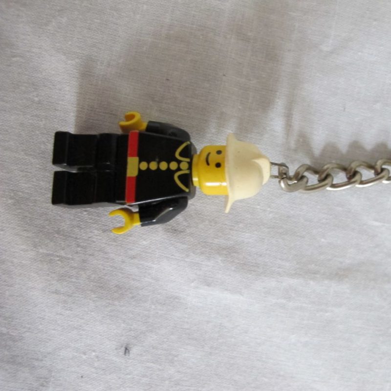 Two keychain minifigures, one fireman, one policeman