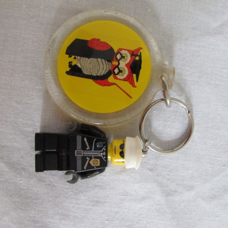 Two keychain minifigures, one fireman, one policeman