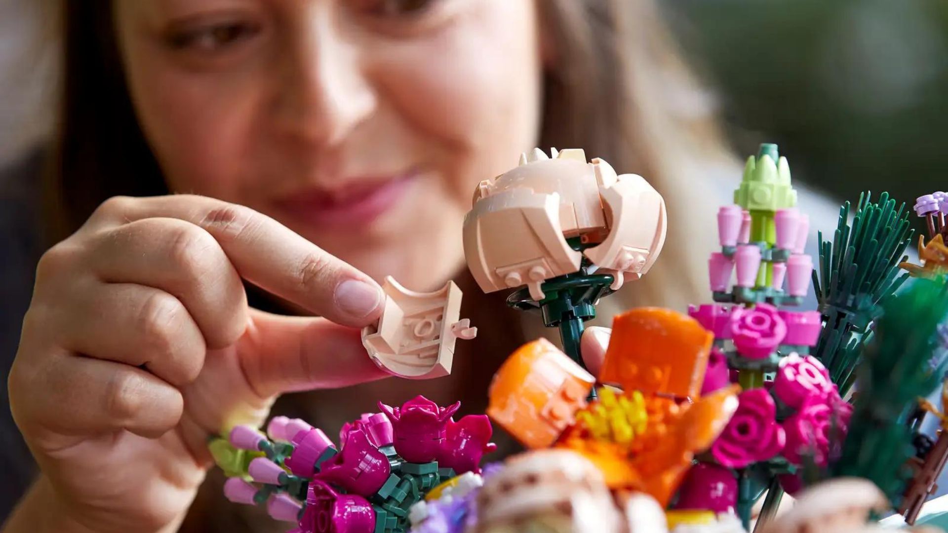 Woman building LEGO Flower Bouquet