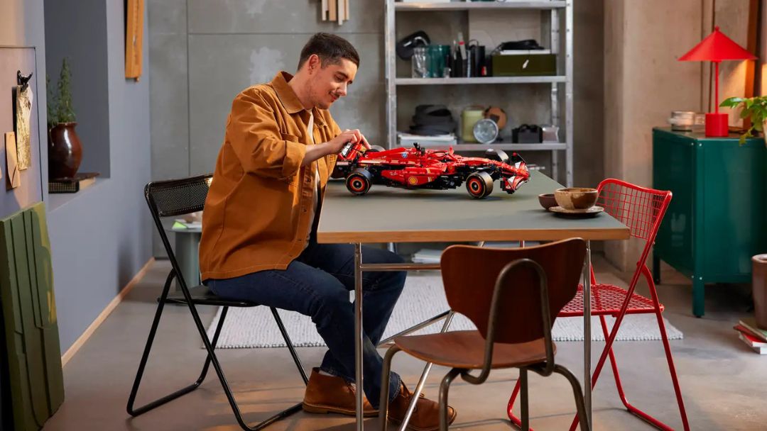 Adult building LEGO Technic Ferrari