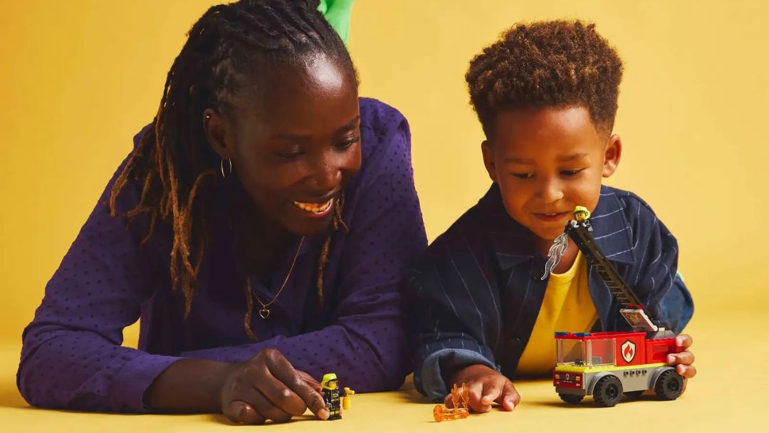 Mother and child playing with LEGO City Firetruck